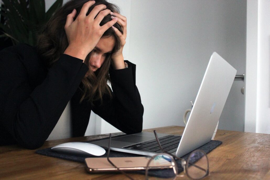 digital marketing strategy is frustrating an employee in front of her laptop and phone at her desk